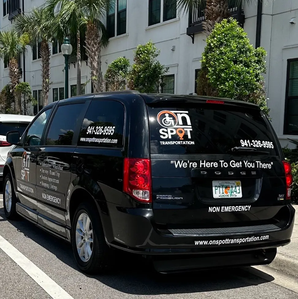 Black transportation vehicle with On Spot Transportation branding